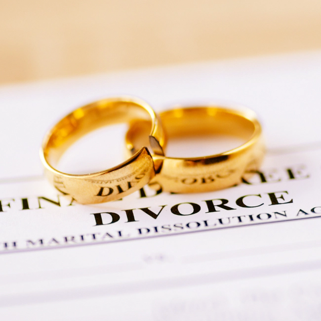intertwined wedding rings on top of divorce papers 1 visalia ca